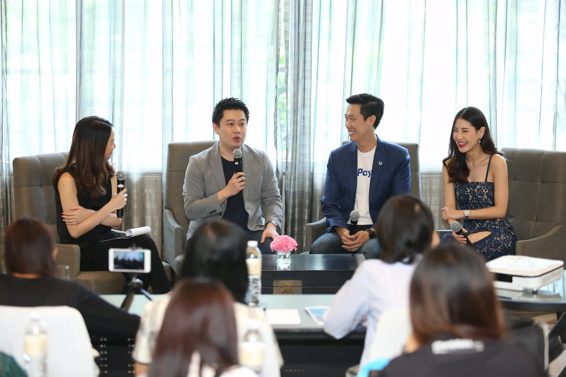 Panel discussion with journalists in the foreground