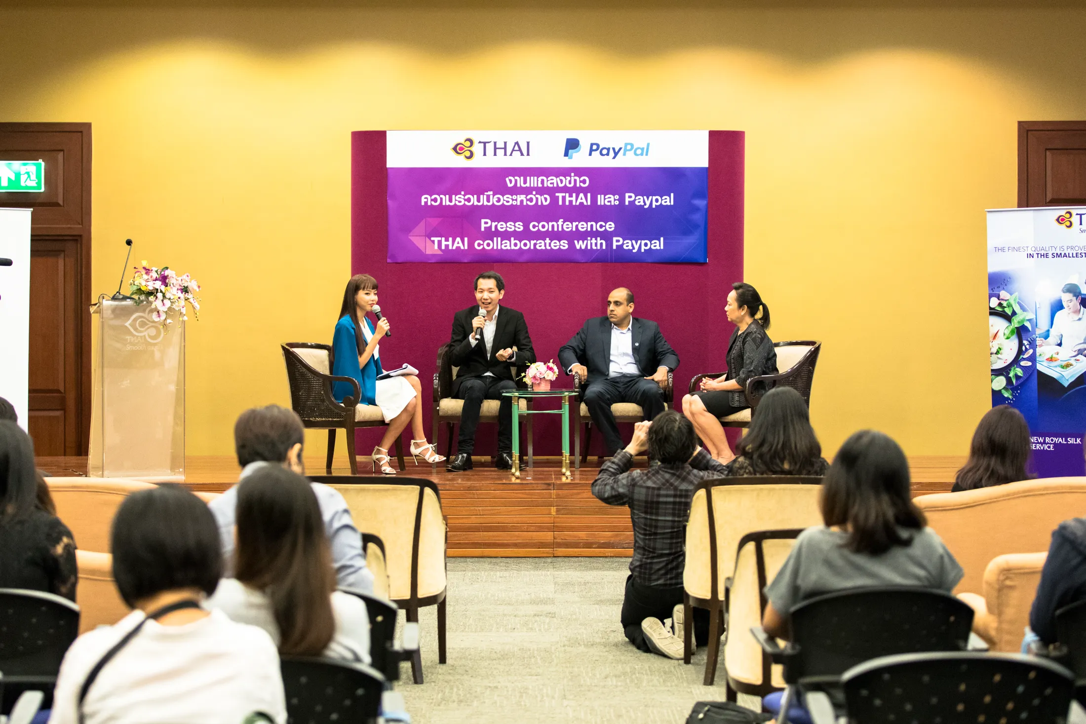 Spokespeople on stage at the press conference in Bangkok